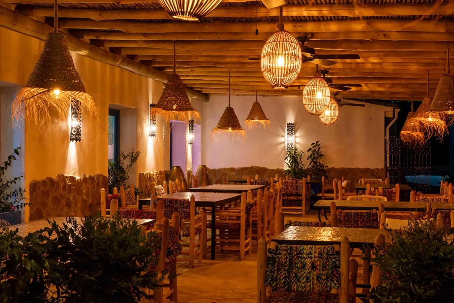 A table laid on the terrace at Jardín Dorado under warm lighting